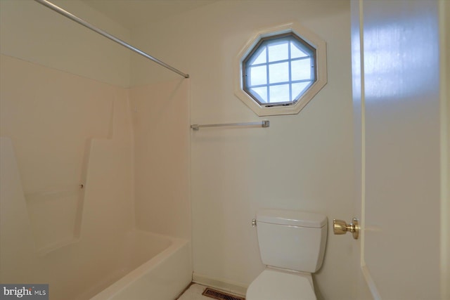 bathroom featuring a shower and toilet