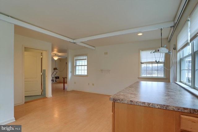 kitchen featuring decorative light fixtures, light hardwood / wood-style flooring, and a wealth of natural light