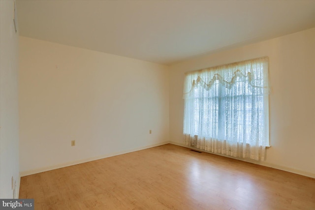 spare room featuring light wood-type flooring