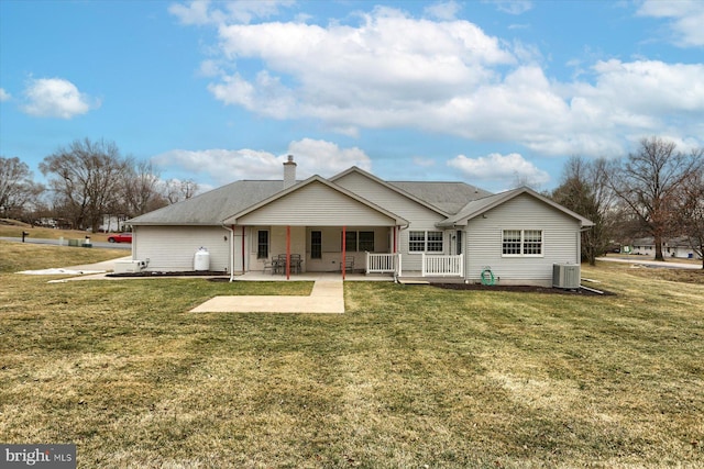 back of property featuring central AC, a patio, and a lawn