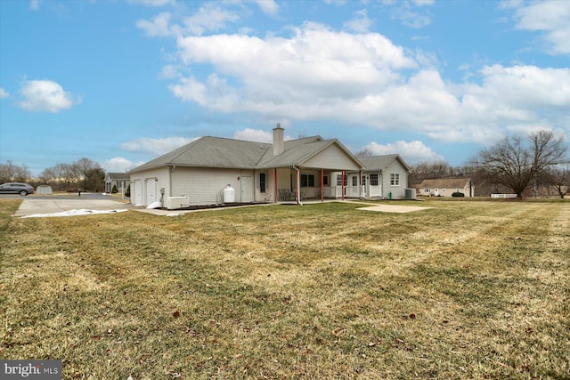 view of front of house with a front yard and covered porch