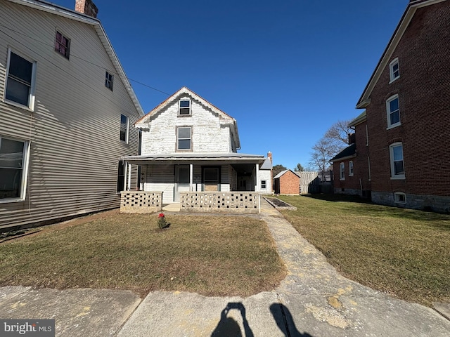 view of front of house featuring a front yard and a porch