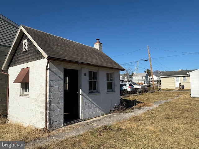 view of outbuilding with a lawn