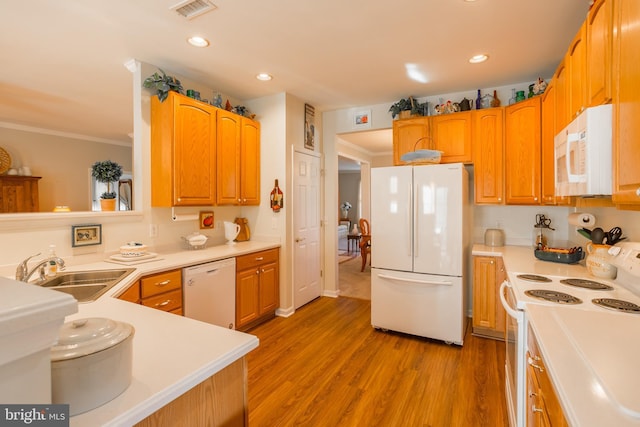 23137 Pine Run, Millsboro, DE 19966 - kitchen with white appliances, ornamental molding, sink, and light hardwood / wood-style flooring