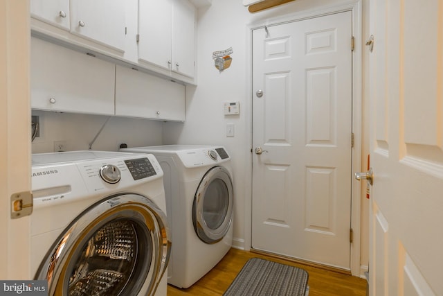 23137 Pine Run, Millsboro, DE 19966 - clothes washing area featuring cabinets, washing machine and clothes dryer, and light hardwood / wood-style floors