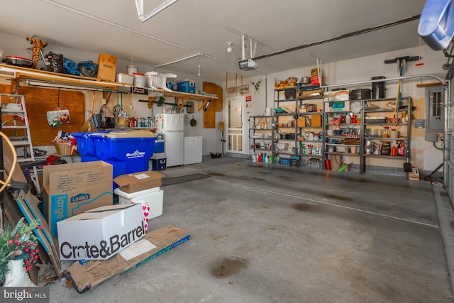 23137 Pine Run, Millsboro, DE 19966 - garage with a garage door opener and white refrigerator