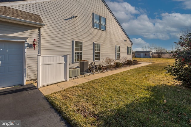 23137 Pine Run, Millsboro, DE 19966 - view of property exterior featuring a garage, a yard, and central AC