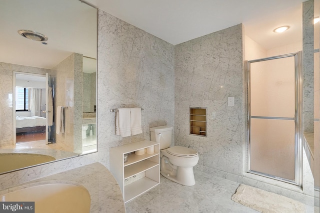 bathroom featuring tile walls, vanity, a shower with door, and toilet