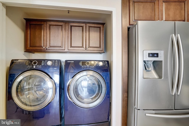 clothes washing area with separate washer and dryer