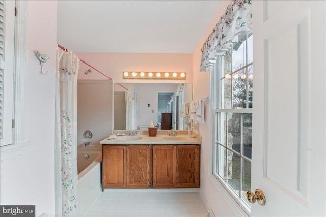 bathroom with vanity, tile patterned flooring, and a bathing tub