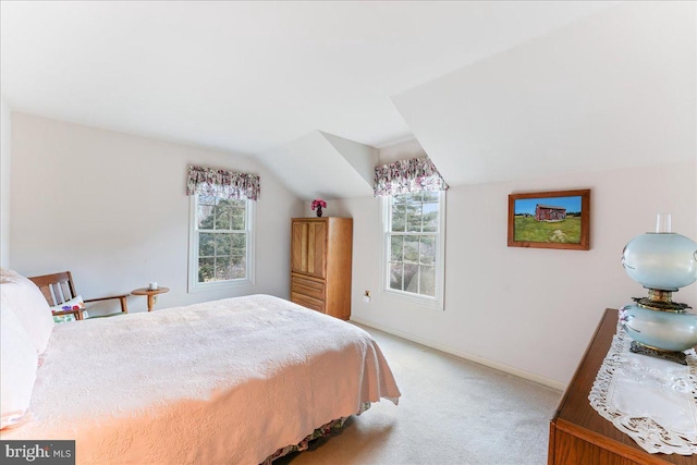 bedroom featuring vaulted ceiling and light colored carpet