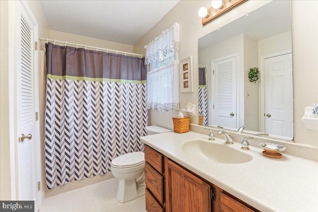 bathroom featuring vanity, a shower with shower curtain, and toilet