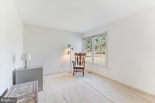 living area with light carpet