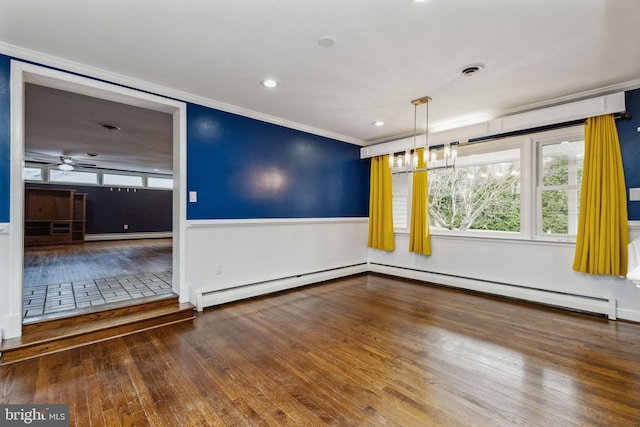 unfurnished room with ornamental molding, a baseboard heating unit, and hardwood / wood-style floors