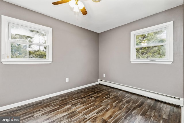 spare room featuring dark wood-type flooring, ceiling fan, and baseboard heating