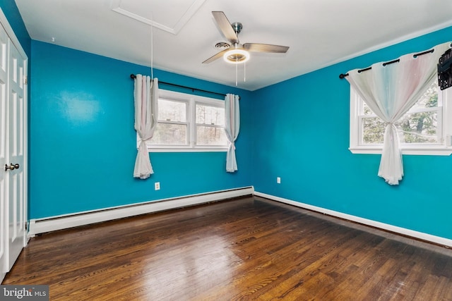 spare room featuring wood-type flooring, baseboard heating, and ceiling fan