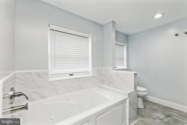 bathroom featuring a washtub and toilet