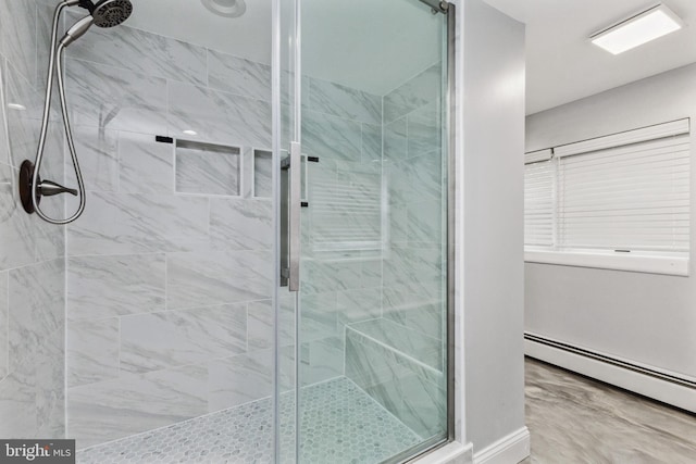 bathroom with a baseboard heating unit and an enclosed shower