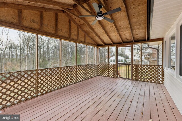 unfurnished sunroom with ceiling fan and lofted ceiling with beams