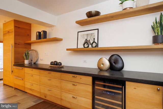 kitchen with beverage cooler and light wood-type flooring