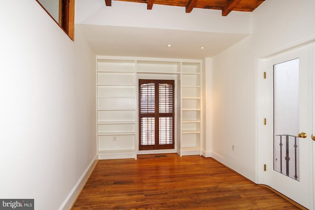 unfurnished room with hardwood / wood-style flooring, built in shelves, beamed ceiling, and french doors