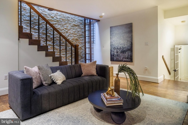 living room with wood-type flooring and a healthy amount of sunlight