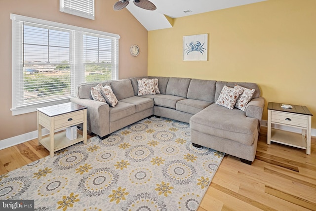 living room featuring ceiling fan, wood-type flooring, and lofted ceiling