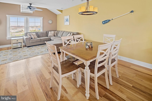 dining space with hardwood / wood-style flooring, lofted ceiling, and ceiling fan