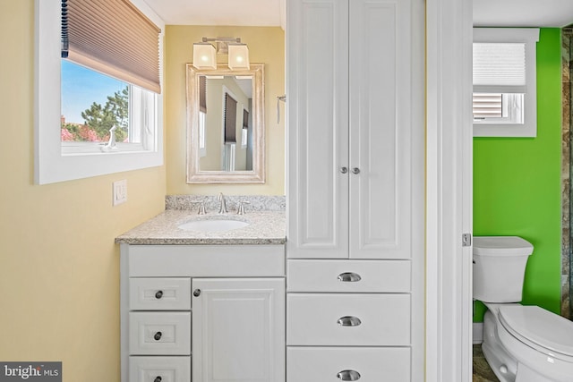 bathroom featuring vanity and toilet