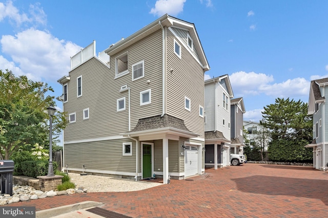 rear view of house featuring a garage