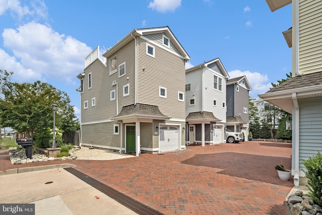 back of property featuring a garage