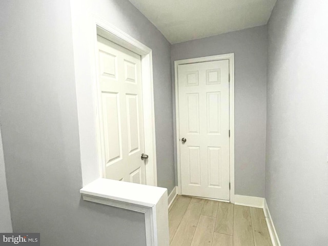 hallway with light hardwood / wood-style floors