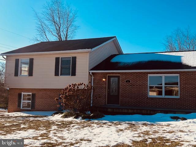 split level home with brick siding