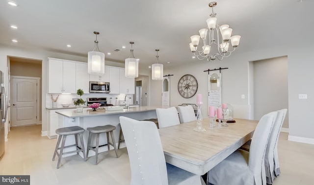 dining area featuring a barn door and a chandelier