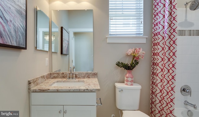 full bathroom with shower / bathtub combination with curtain, vanity, and toilet