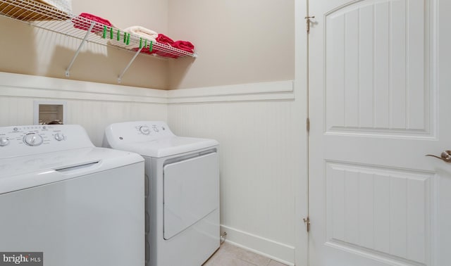 clothes washing area featuring washer and dryer and light tile patterned flooring