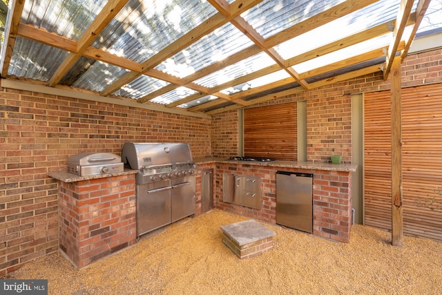 view of patio with area for grilling and an outdoor kitchen