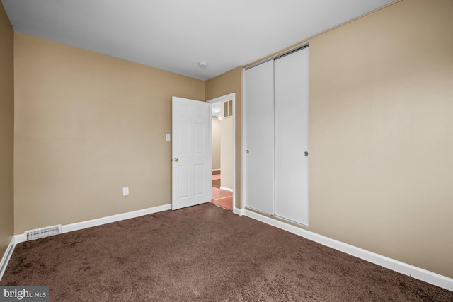 unfurnished bedroom with carpet floors and a closet