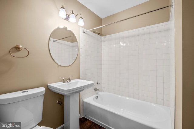 full bathroom featuring tiled shower / bath, sink, and toilet