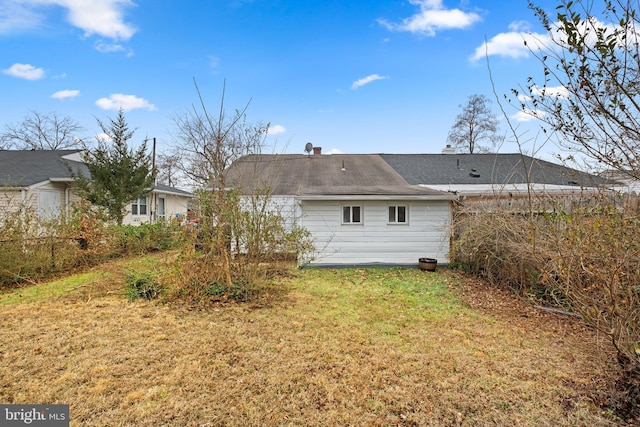 rear view of property with a yard