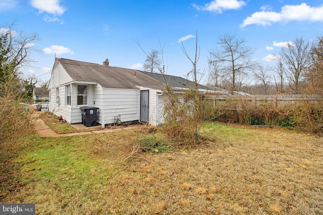 rear view of property with a lawn