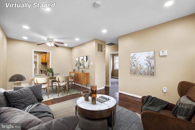 living room with wood-type flooring and ceiling fan