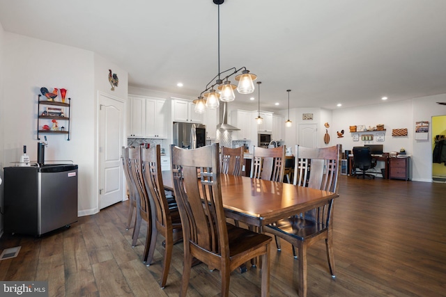 dining area with dark hardwood / wood-style flooring