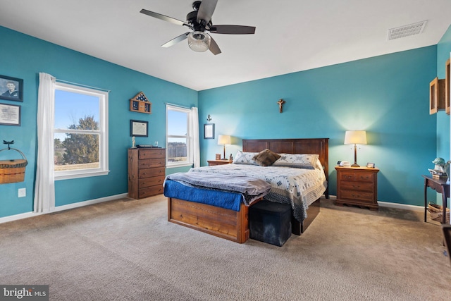 bedroom featuring light carpet and ceiling fan