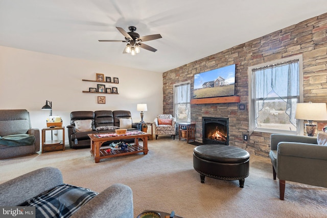 living room featuring ceiling fan, carpet floors, and a fireplace