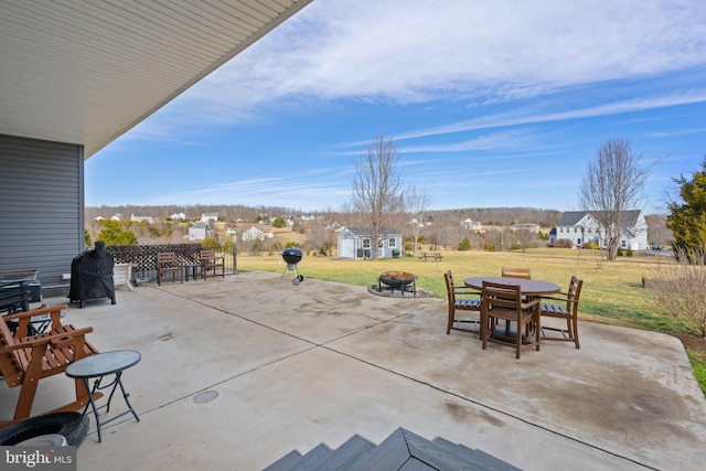 view of patio / terrace with a shed and a fire pit