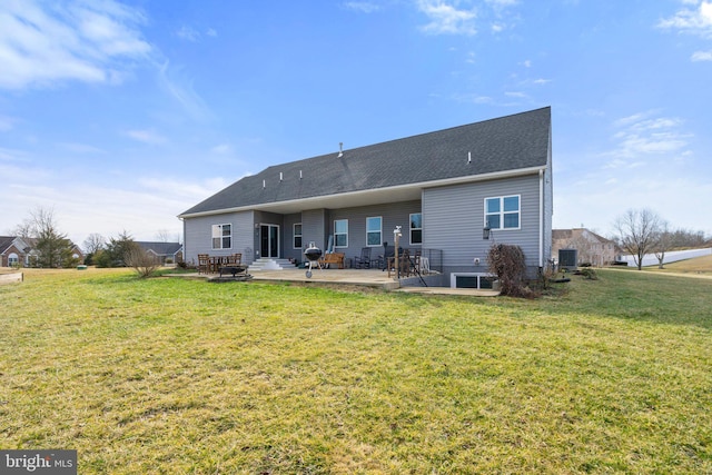 rear view of property featuring cooling unit, a yard, and a patio area