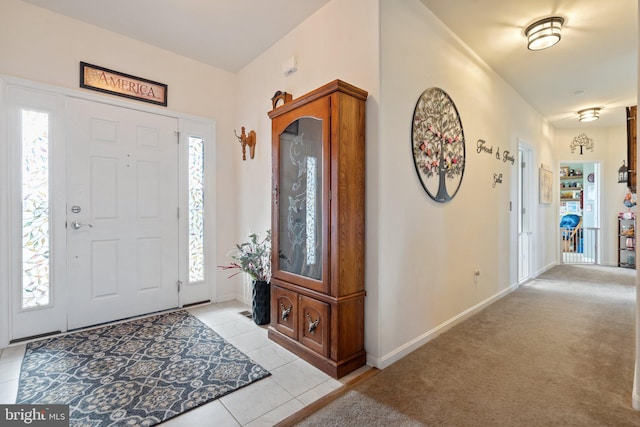 foyer entrance with light tile patterned floors and a wealth of natural light