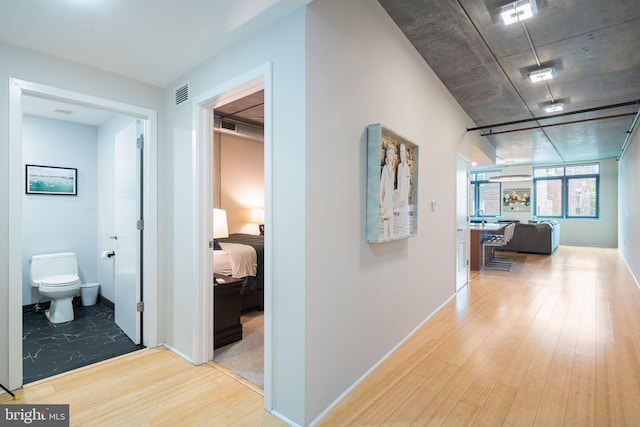 hallway with light hardwood / wood-style flooring