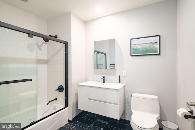 full bathroom featuring vanity, toilet, and combined bath / shower with glass door